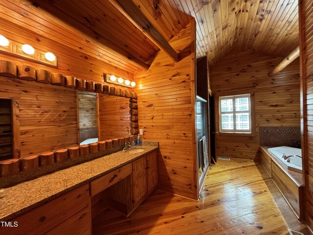 603 Hugo St, Durham, NC 27704 - bathroom with vanity, wooden walls, lofted ceiling, a garden tub, and wood-type flooring