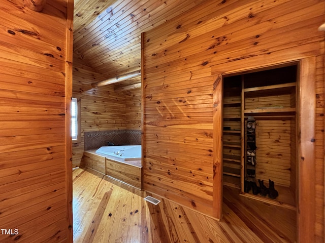 603 Hugo St, Durham, NC 27704 - full bath featuring wood walls, wood-type flooring, tiled bath, lofted ceiling, and wood ceiling