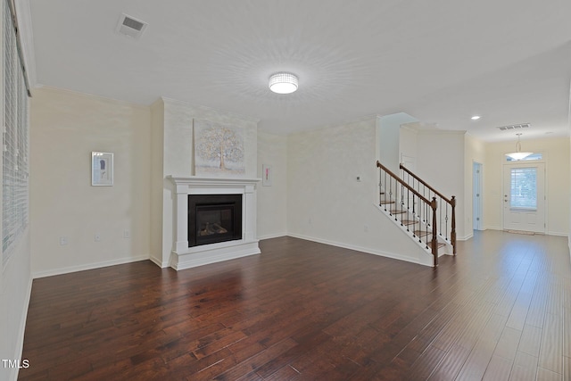 317 Springhurst Ln, Cary, NC 27511 - unfurnished living room featuring stairway, wood finished floors, baseboards, a glass covered fireplace, and recessed lighting