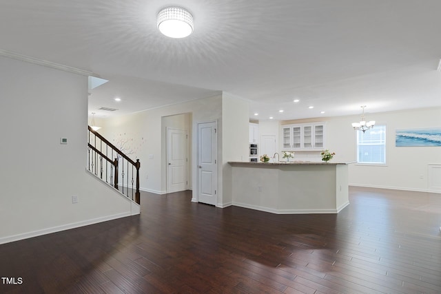 317 Springhurst Ln, Cary, NC 27511 - unfurnished living room featuring a chandelier, stairs, dark wood-type flooring, baseboards, and recessed lighting