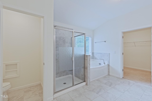 317 Springhurst Ln, Cary, NC 27511 - full bath with a garden tub, a shower stall, a walk in closet, lofted ceiling, and baseboards