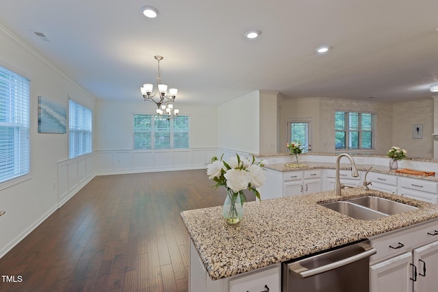 317 Springhurst Ln, Cary, NC 27511 - kitchen with dishwasher, a sink, a kitchen island with sink, a chandelier, and white cabinetry
