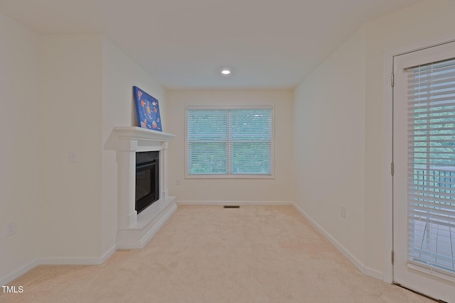 317 Springhurst Ln, Cary, NC 27511 - unfurnished living room featuring carpet flooring, baseboards, a glass covered fireplace, and recessed lighting