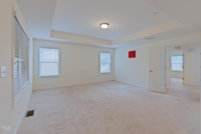 317 Springhurst Ln, Cary, NC 27511 - unfurnished bedroom with a tray ceiling, light colored carpet, and baseboards
