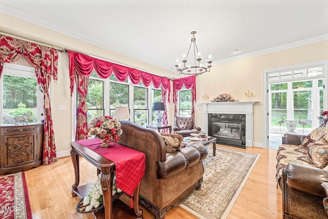 1317 Woodgate Manor Ct, Raleigh, NC 27614 - living area featuring ornamental molding, a chandelier, a premium fireplace, and light wood finished floors