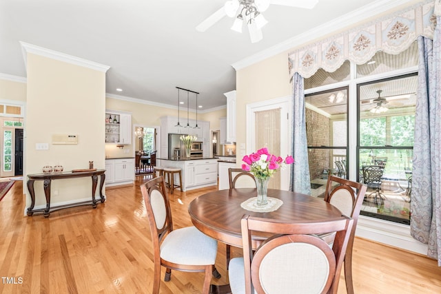 1317 Woodgate Manor Ct, Raleigh, NC 27614 - dining room featuring a ceiling fan, crown molding, and light wood-style flooring