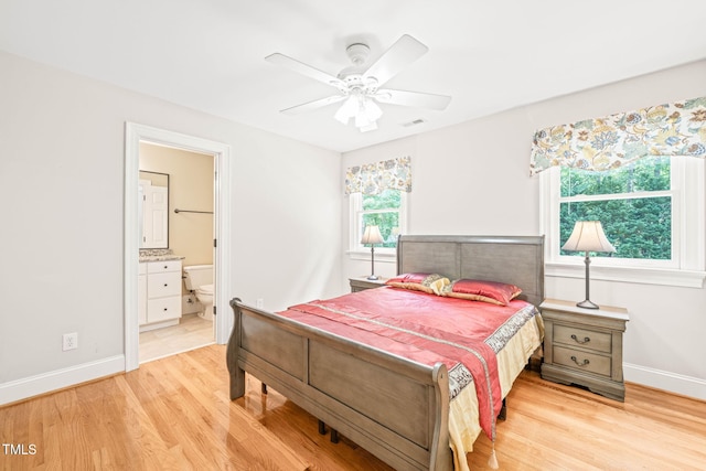 1317 Woodgate Manor Ct, Raleigh, NC 27614 - bedroom with light wood-style flooring, ensuite bathroom, and ceiling fan