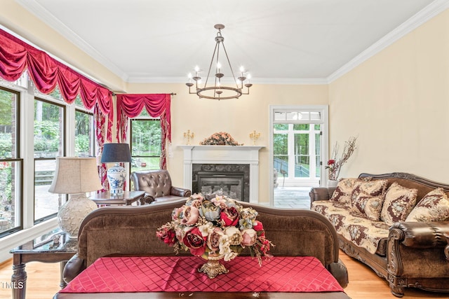 1317 Woodgate Manor Ct, Raleigh, NC 27614 - living area featuring a chandelier, wood finished floors, ornamental molding, and a premium fireplace