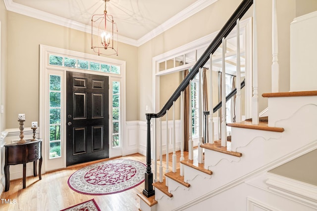 1317 Woodgate Manor Ct, Raleigh, NC 27614 - foyer with stairs, wood finished floors, ornamental molding, a chandelier, and a wainscoted wall