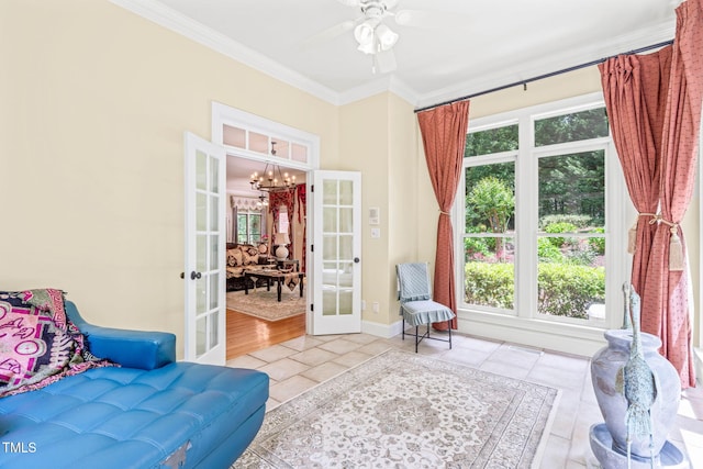 1317 Woodgate Manor Ct, Raleigh, NC 27614 - living area featuring french doors, tile patterned flooring, a chandelier, crown molding, and a ceiling fan