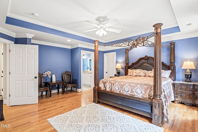 1317 Woodgate Manor Ct, Raleigh, NC 27614 - bedroom featuring ornate columns, light wood finished floors, connected bathroom, crown molding, and ceiling fan