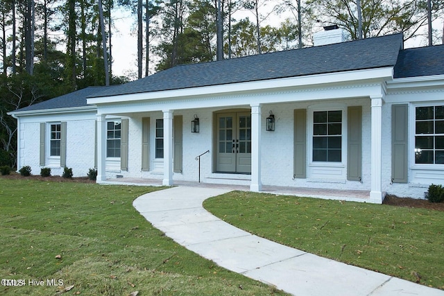 1204 Windemere Pl, Wilson, NC 27893 - view of front of home featuring covered porch, a chimney, a front yard, a shingled roof, and french doors
