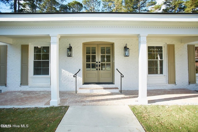 1204 Windemere Pl, Wilson, NC 27893 - view of exterior entry featuring a porch, stucco siding, and french doors