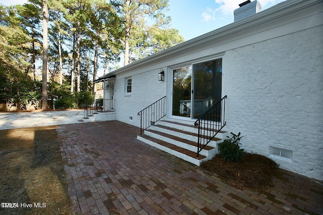 1204 Windemere Pl, Wilson, NC 27893 - doorway to property featuring a chimney, a patio, and crawl space