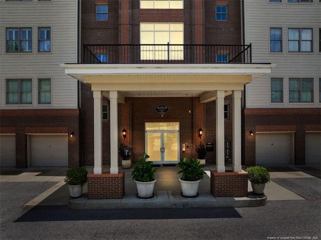 220 Hugh Shelton Loop, Fayetteville, NC 28303 - doorway to property featuring brick siding, a balcony, and a garage