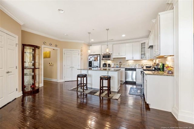 220 Hugh Shelton Loop, Fayetteville, NC 28303 - kitchen with stainless steel appliances, a breakfast bar, a center island, white cabinetry, and glass insert cabinets