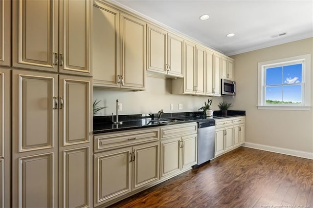220 Hugh Shelton Loop, Fayetteville, NC 28303 - kitchen with cream cabinetry, appliances with stainless steel finishes, a sink, recessed lighting, and ornamental molding