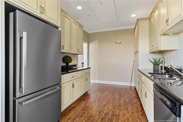 220 Hugh Shelton Loop, Fayetteville, NC 28303 - kitchen with appliances with stainless steel finishes, cream cabinetry, a sink, dark countertops, and ornamental molding