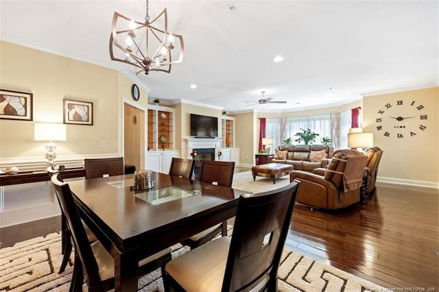 220 Hugh Shelton Loop, Fayetteville, NC 28303 - dining room featuring crown molding, a fireplace, dark wood-style flooring, a chandelier, and baseboards