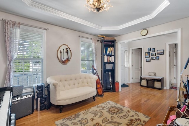 40 Union Cir, Lillington, NC 27546 - sitting room with light wood-style flooring, a chandelier, ornamental molding, and a raised ceiling
