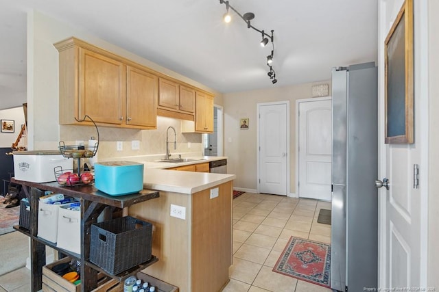 40 Union Cir, Lillington, NC 27546 - kitchen with a sink, freestanding refrigerator, light countertops, a peninsula, and light brown cabinetry