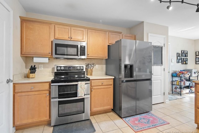 40 Union Cir, Lillington, NC 27546 - kitchen featuring appliances with stainless steel finishes, light countertops, tasteful backsplash, and light tile patterned flooring