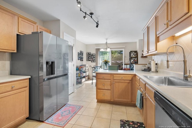 40 Union Cir, Lillington, NC 27546 - kitchen featuring appliances with stainless steel finishes, a sink, light tile patterned floors, a peninsula, and tasteful backsplash