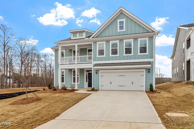219 Berry Mill Ln Unit 179, Raleigh, NC 27603 - view of front of house featuring board and batten siding, a porch, concrete driveway, an attached garage, and a front lawn