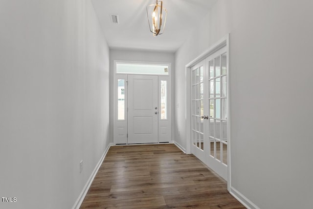 219 Berry Mill Ln Unit 179, Raleigh, NC 27603 - foyer featuring french doors, wood finished floors, baseboards, and a chandelier