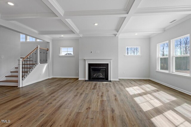 219 Berry Mill Ln Unit 179, Raleigh, NC 27603 - unfurnished living room featuring coffered ceiling, stairway, wood finished floors, beam ceiling, and baseboards