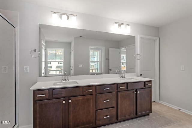 219 Berry Mill Ln Unit 179, Raleigh, NC 27603 - bathroom with double vanity, tile patterned flooring, an enclosed shower, and baseboards