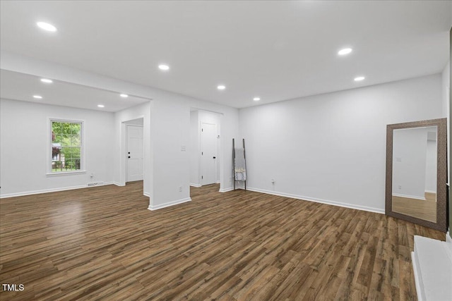 5110 Old Well St, Durham, NC 27704 - unfurnished living room with dark wood-type flooring, recessed lighting, and baseboards