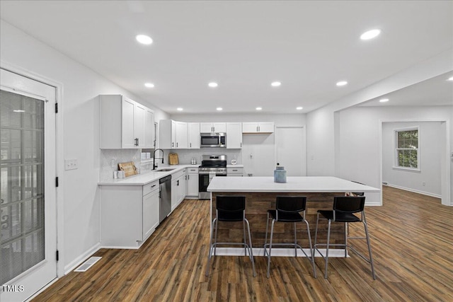 5110 Old Well St, Durham, NC 27704 - kitchen with appliances with stainless steel finishes, a sink, dark wood finished floors, light countertops, and recessed lighting