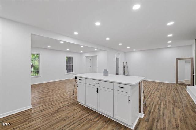 5110 Old Well St, Durham, NC 27704 - kitchen featuring open floor plan, dark wood finished floors, a kitchen island, white cabinetry, and baseboards