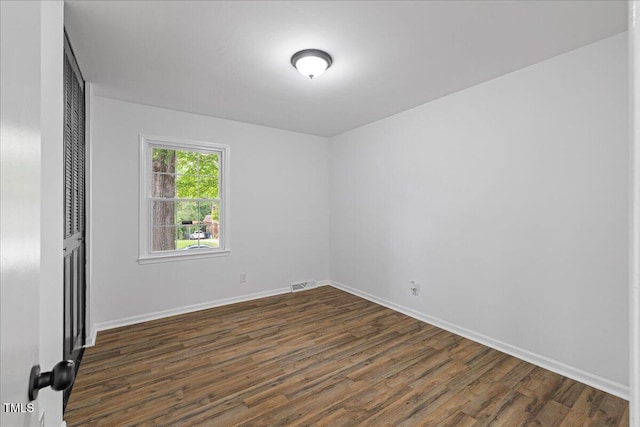 5110 Old Well St, Durham, NC 27704 - empty room with dark wood-type flooring and baseboards