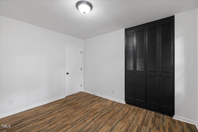5110 Old Well St, Durham, NC 27704 - unfurnished bedroom featuring dark wood finished floors, a closet, and baseboards