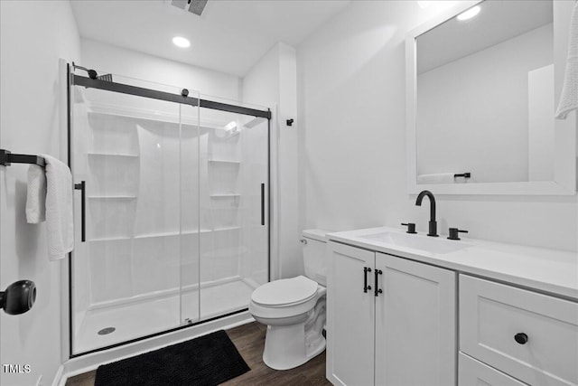 5110 Old Well St, Durham, NC 27704 - full bathroom with toilet, a shower stall, vanity, wood finished floors, and recessed lighting
