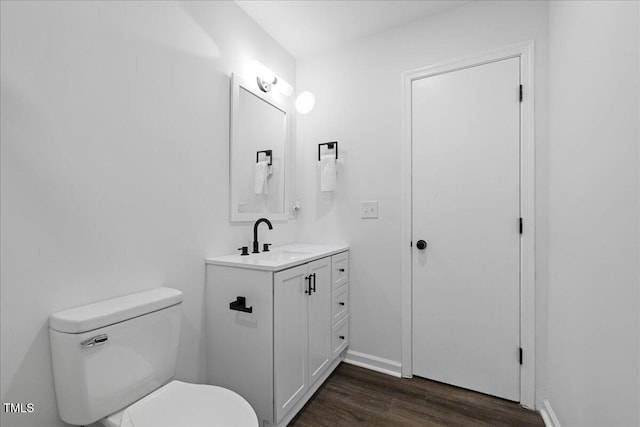 5110 Old Well St, Durham, NC 27704 - half bath with toilet, wood finished floors, vanity, and baseboards