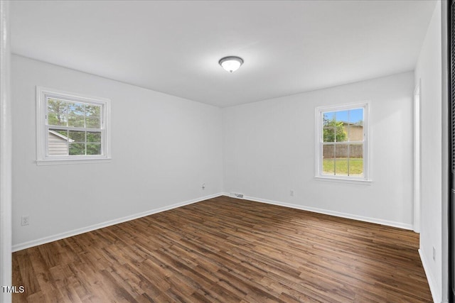 5110 Old Well St, Durham, NC 27704 - unfurnished room with healthy amount of natural light, dark wood finished floors, and baseboards