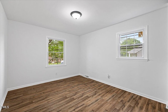 5110 Old Well St, Durham, NC 27704 - spare room featuring dark wood-style flooring and baseboards