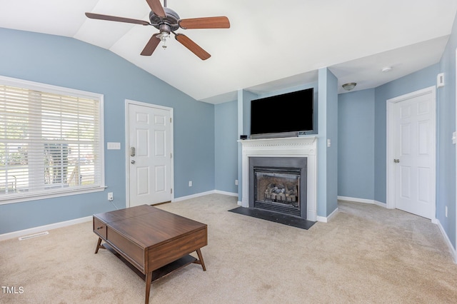 6 N Carolina Ave, Benson, NC 27504 - living area featuring vaulted ceiling, a fireplace with flush hearth, light colored carpet, a ceiling fan, and baseboards