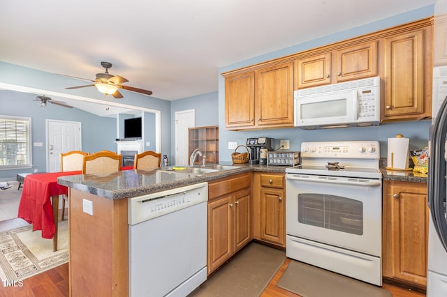 6 N Carolina Ave, Benson, NC 27504 - kitchen featuring white appliances, a sink, a peninsula, a ceiling fan, and dark countertops