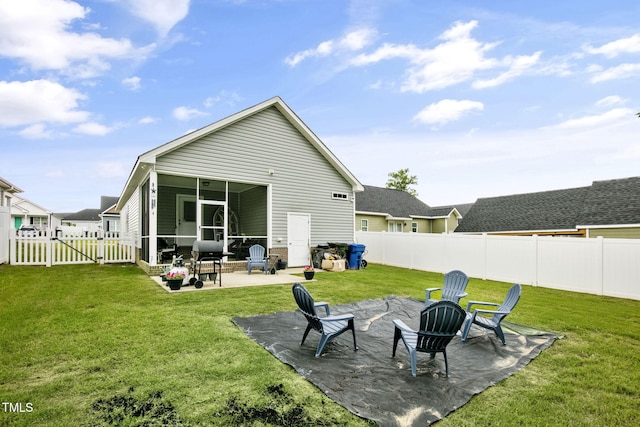 3501 Cranberry Ridge Dr SW, Wilson, NC 27893 - back of house featuring a sunroom, a patio area, a fire pit, and a gate