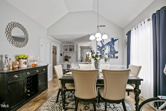 3501 Cranberry Ridge Dr SW, Wilson, NC 27893 - dining space with a chandelier, wood finished floors, and vaulted ceiling
