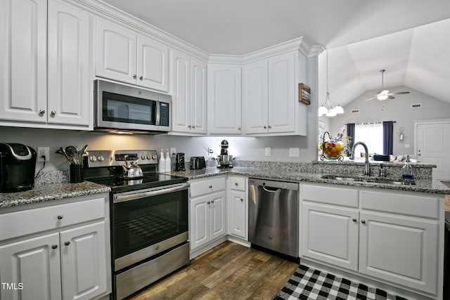3501 Cranberry Ridge Dr SW, Wilson, NC 27893 - kitchen with appliances with stainless steel finishes, a sink, a ceiling fan, vaulted ceiling, and white cabinets