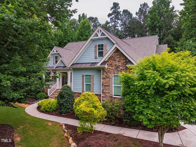 201 Margaret Mann Way, Pittsboro, NC 27312 - craftsman inspired home featuring stone siding, a standing seam roof, a shingled roof, and a front lawn