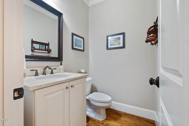 201 Margaret Mann Way, Pittsboro, NC 27312 - half bathroom with vanity, toilet, wood finished floors, baseboards, and crown molding