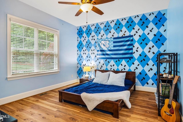 201 Margaret Mann Way, Pittsboro, NC 27312 - bedroom with baseboards, an accent wall, wood finished floors, and ceiling fan