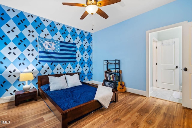 201 Margaret Mann Way, Pittsboro, NC 27312 - bedroom with an accent wall, baseboards, wood finished floors, and a ceiling fan