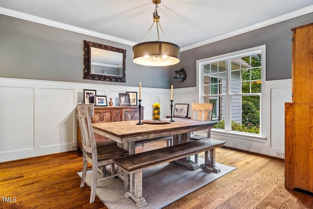 201 Margaret Mann Way, Pittsboro, NC 27312 - dining space featuring a decorative wall, light wood-style floors, wainscoting, and crown molding